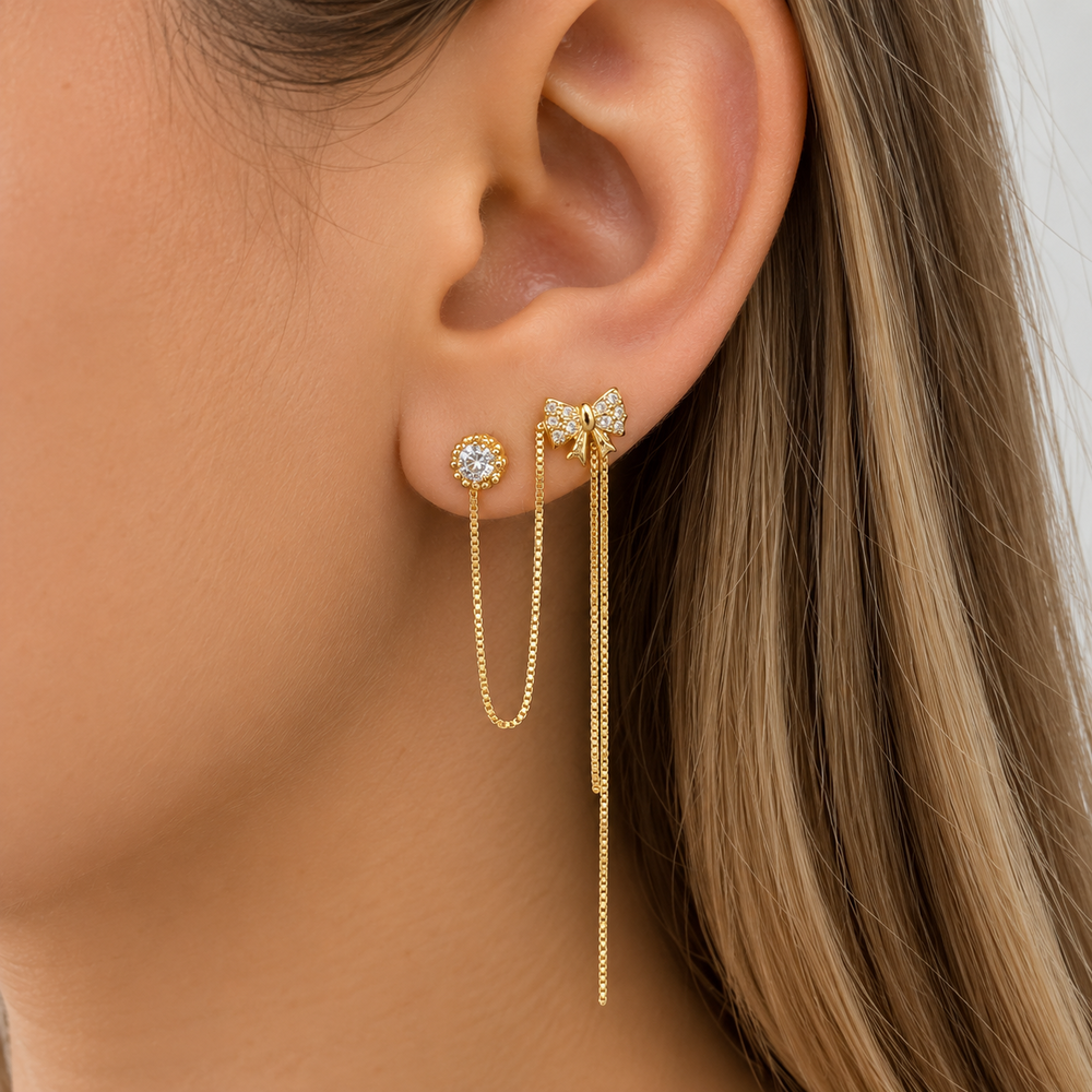 Brinco Interligado Estilo Ponto de Luz e Laço Cravejado Banhado a Ouro 18k com Zircônias
