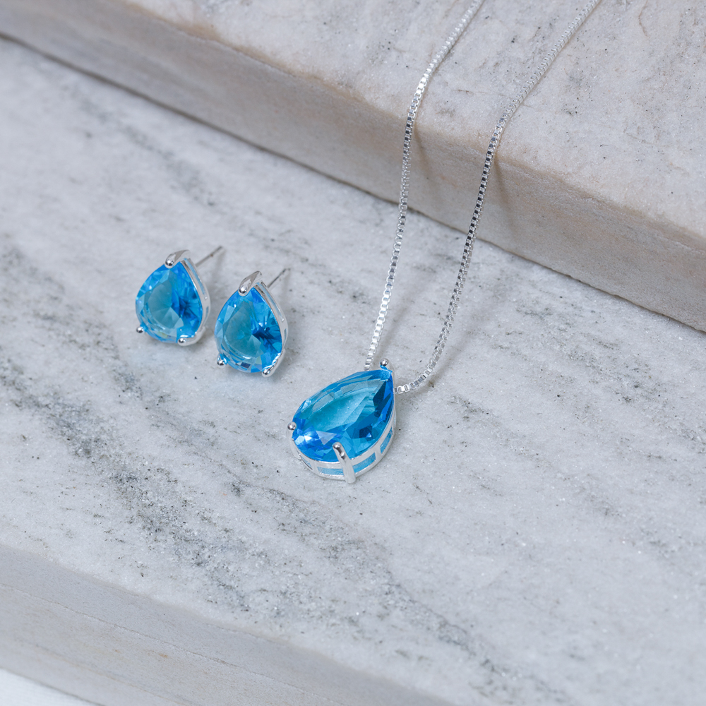 CONJUNTO GOTA COM PEDRA AZUL CLARO BANHO PRATA