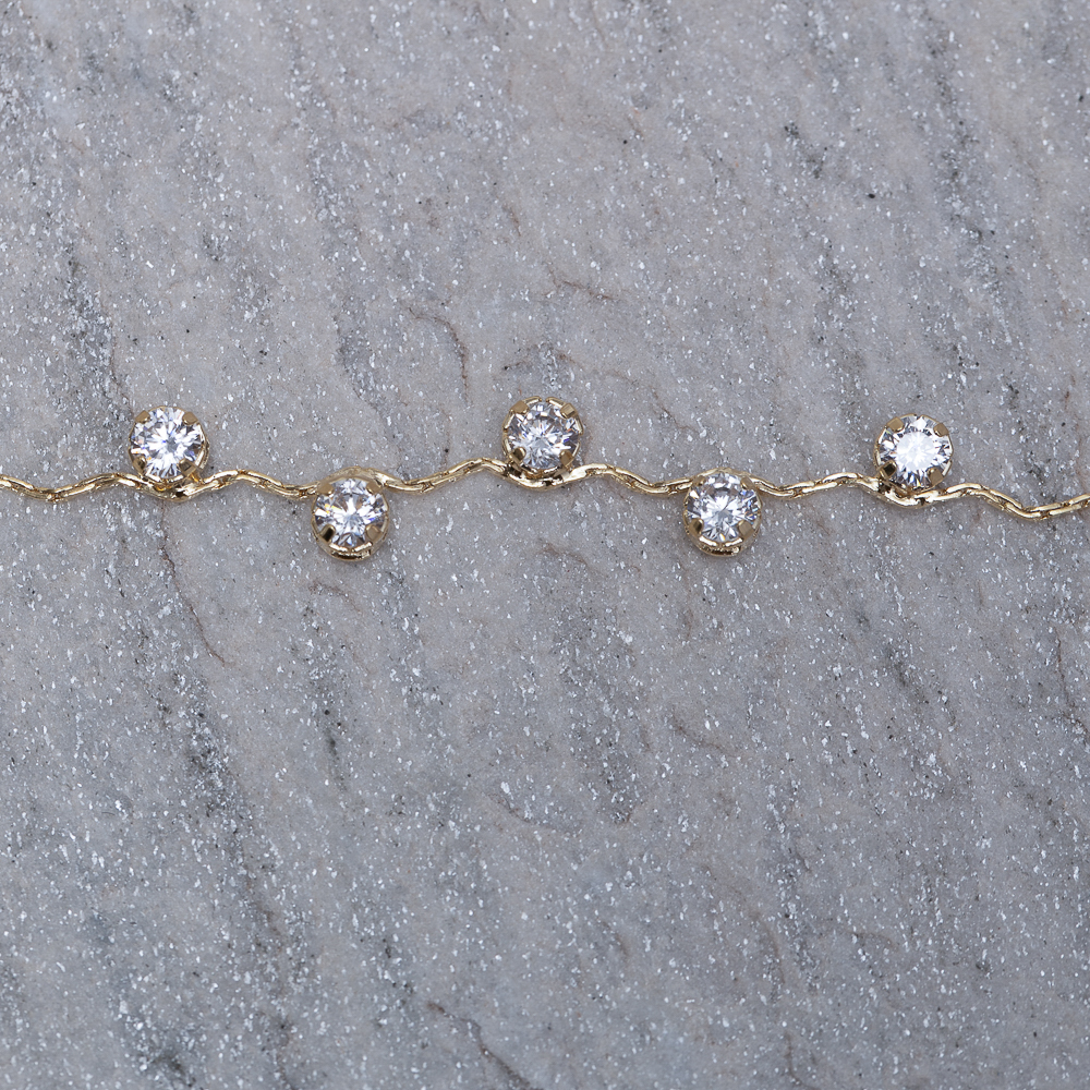 PULSEIRA ONDULADA COM PEDRAS CRISTAIS BANHO 18K