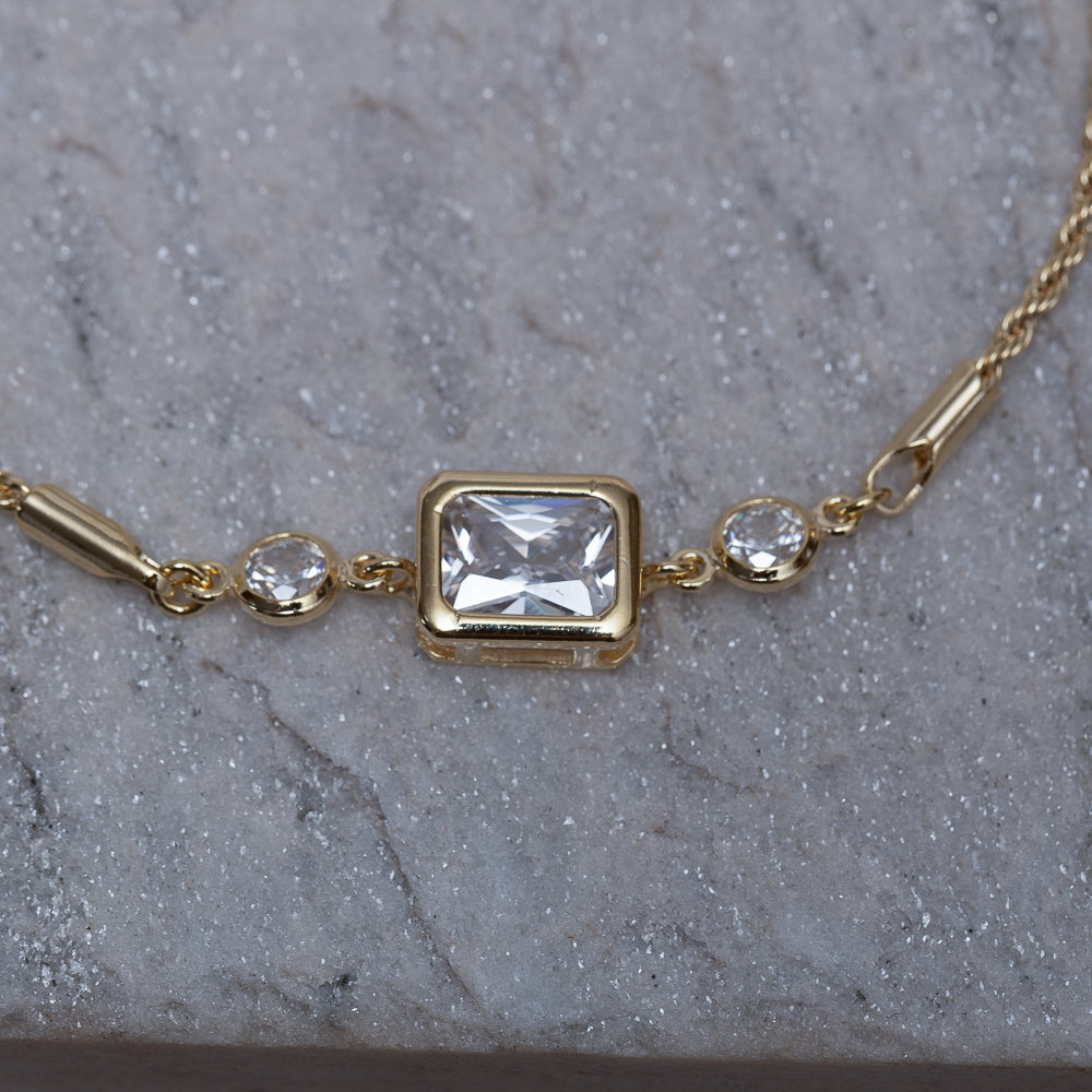 PULSEIRA CABO DE AÇO PP E PEDRA CRISTAL BANHO 18K