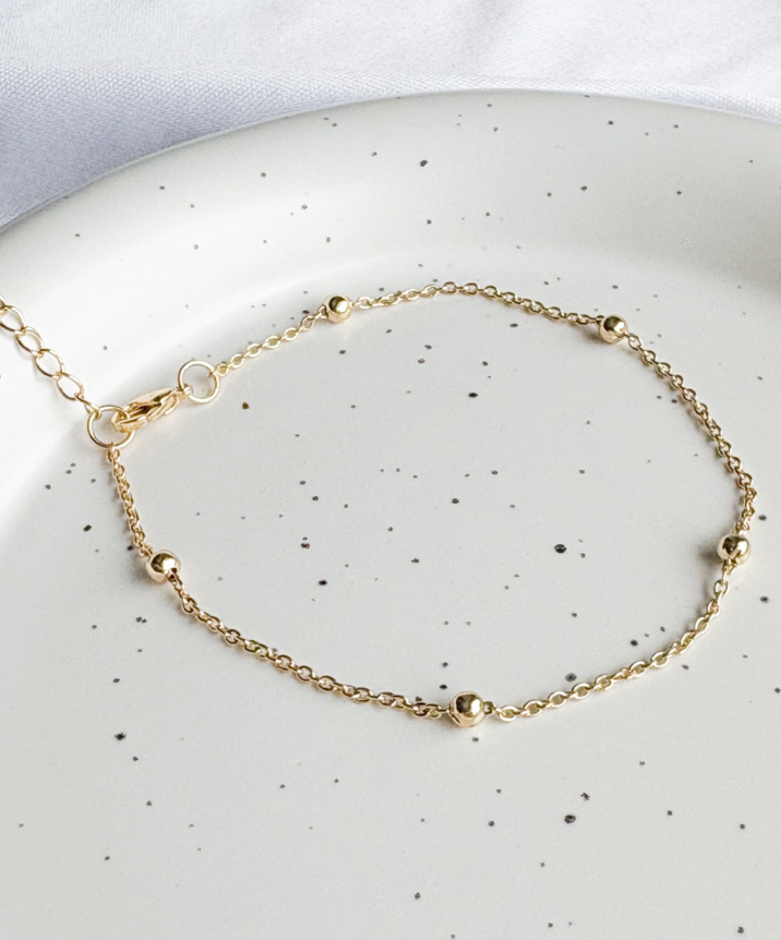 PULSEIRA MALHA C/ 5 BOLINHAS B. OURO
